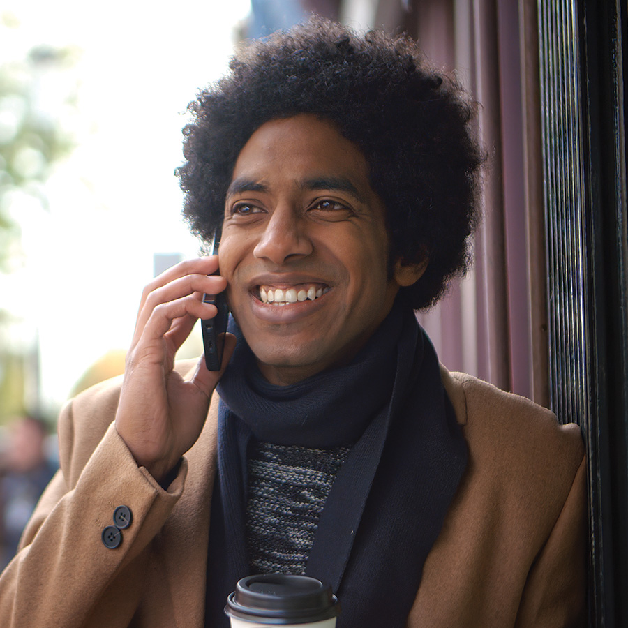 stylish young man with takeaway coffee making phon 2026 03 25 08 36 07 utc